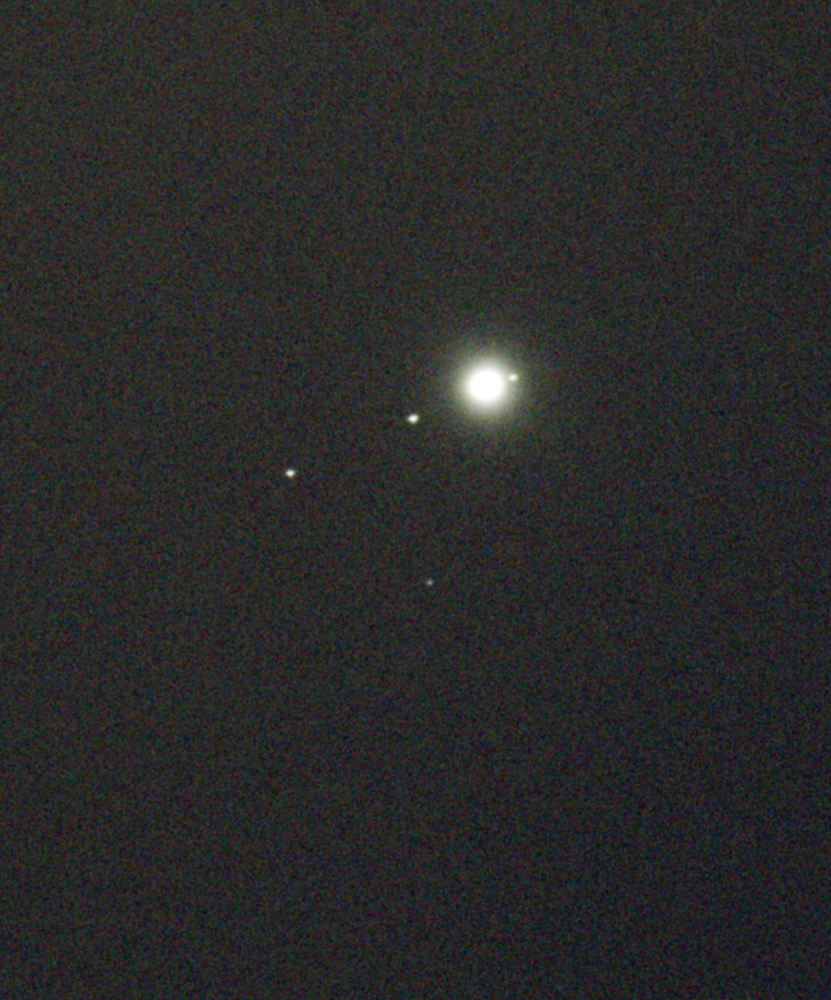 Jupiter and 4 of its Galilean moons. The 4th moon is in front of Jupiter and can’t be seen, I’m not sure what that dot in the bottom left is.