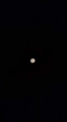 Jupiter. You can see some of Jupiter’s bands if you squint.